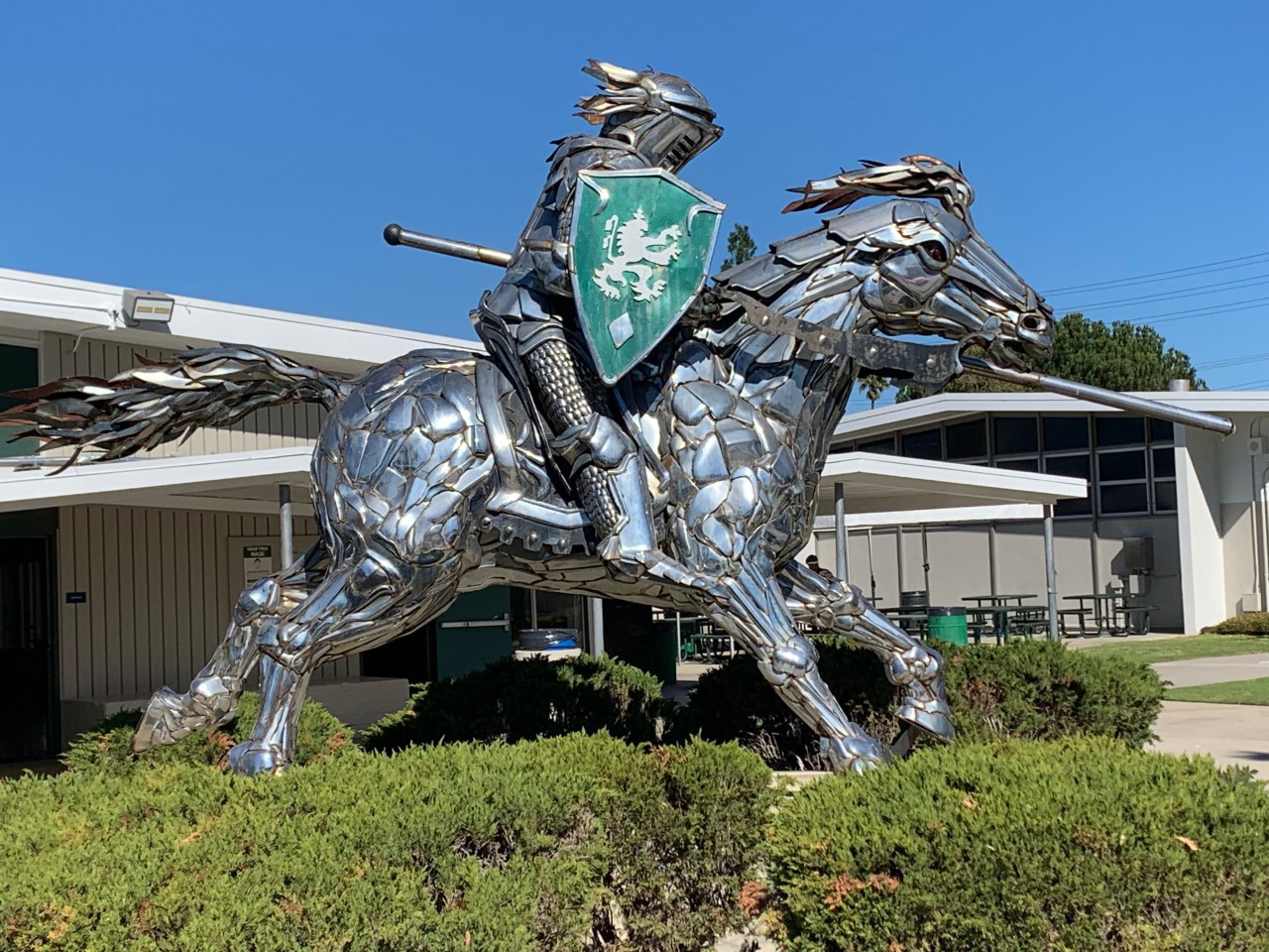 Statue of the school mascot, a knight riding a horse all in chrome